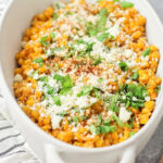 Close up image of Mexican street corn in white bowl.