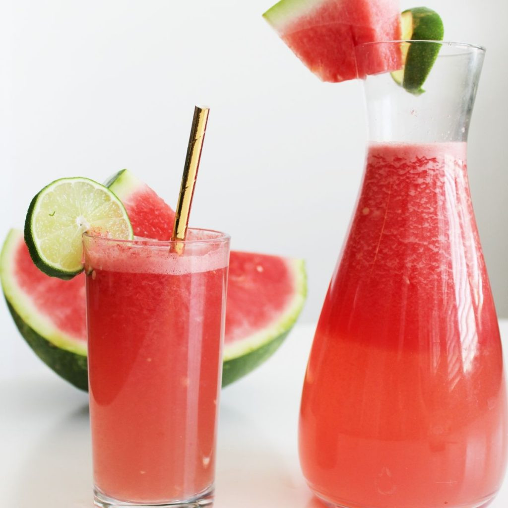 Close-up of a glass of Mexican watermelon water, showing the vibrant pink color and refreshing look.