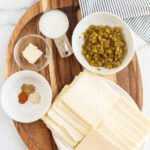 Ingredients for making authentic Mexican queso blanco with white cheese, green chilies, and spices