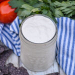 Mexican white sauce in a small glass jar