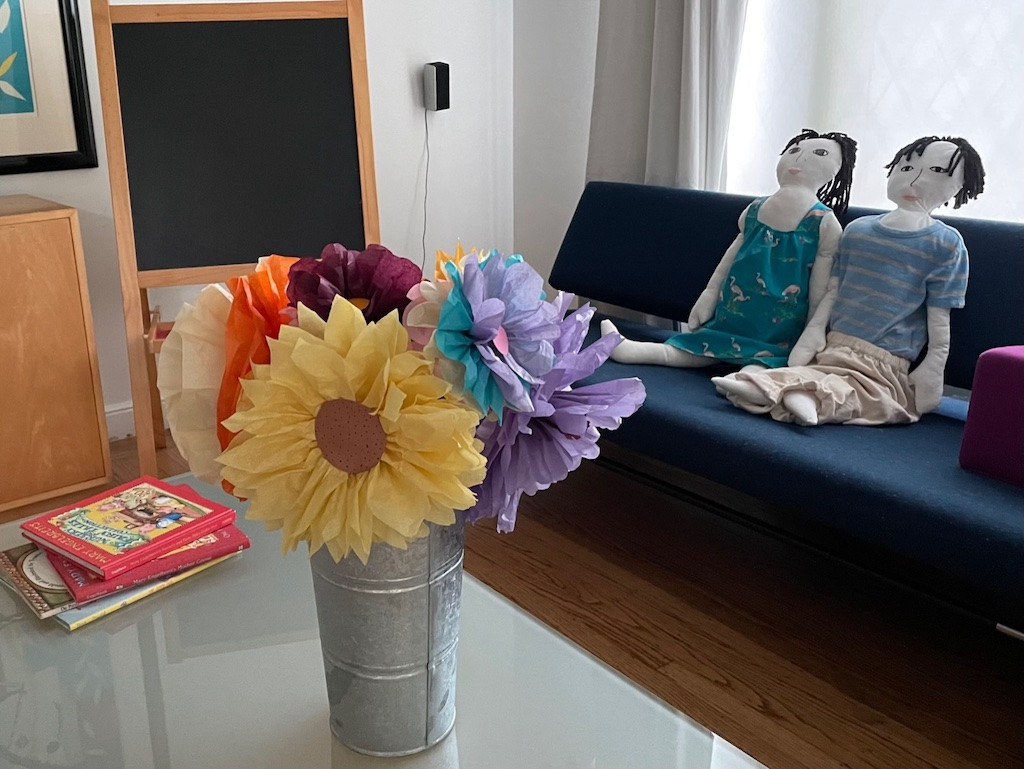 Tissue paper flowers in a French flower bucket.