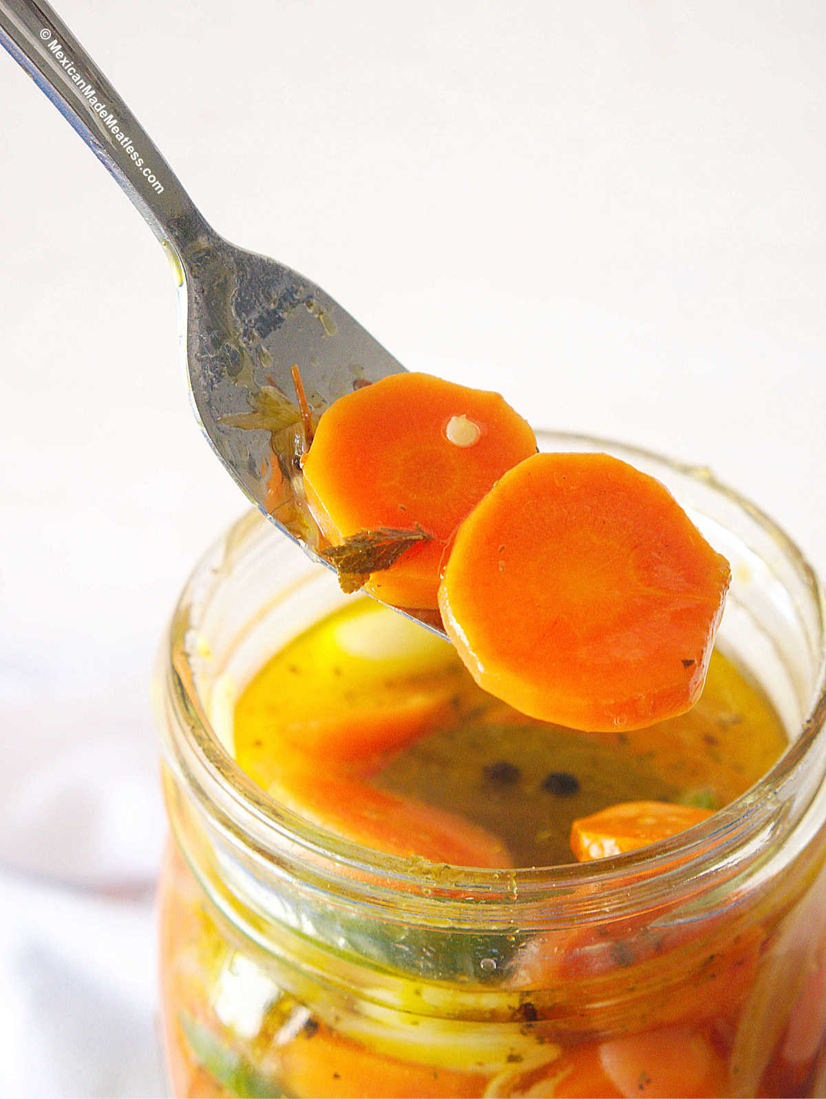 A close-up of Mexican Spicy Pickled Carrots, emphasizing their vibrant colors, varied textures, and the perfect balance of crispness and tenderness.