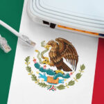 Mexican flag on a table with an internet cable, representing internet access in Mexico