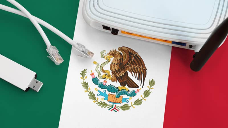 Mexican flag on a table with an internet cable, representing internet access in Mexico