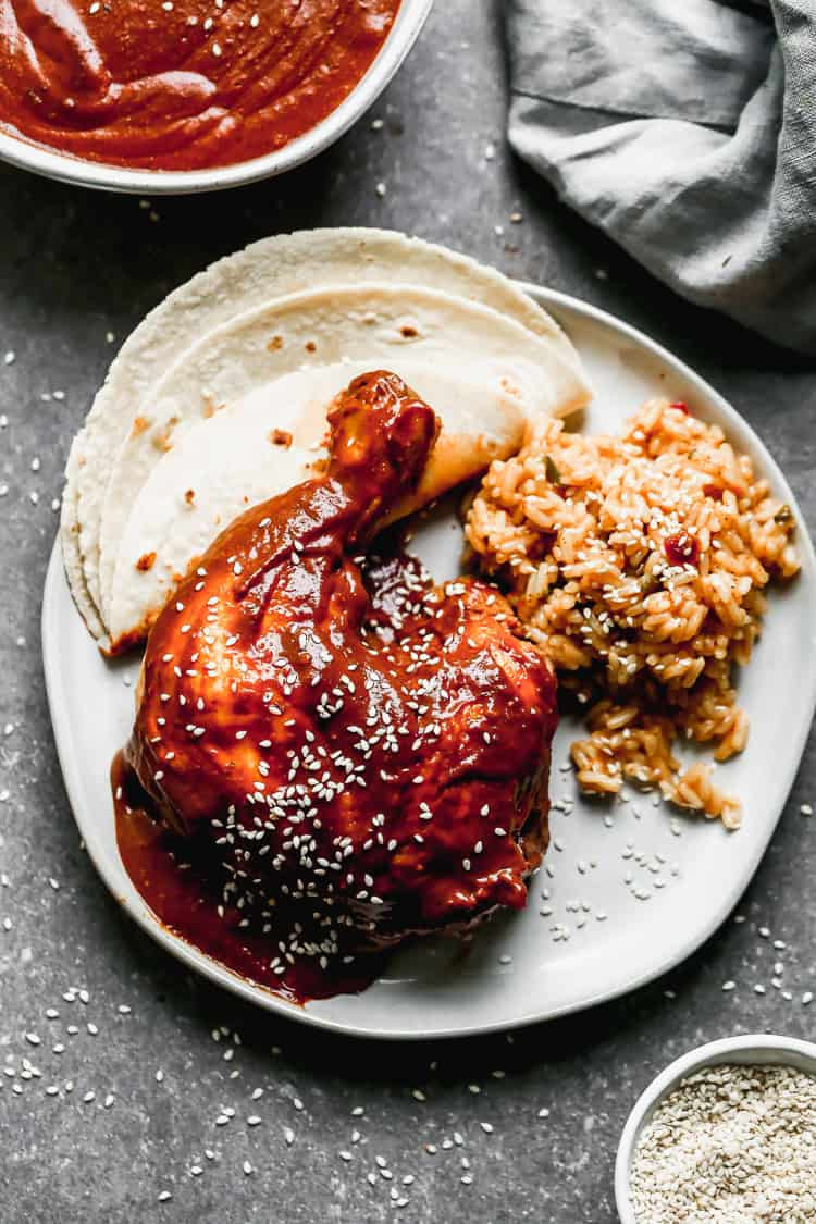 An easy mole recipe served over chicken with Mexican rice and tortillas on the side.