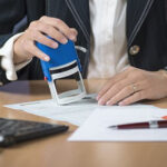 Notary public stamping letter of permission from a lender