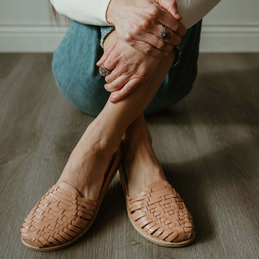 Woman in jeans wearing wide toe box huaraches