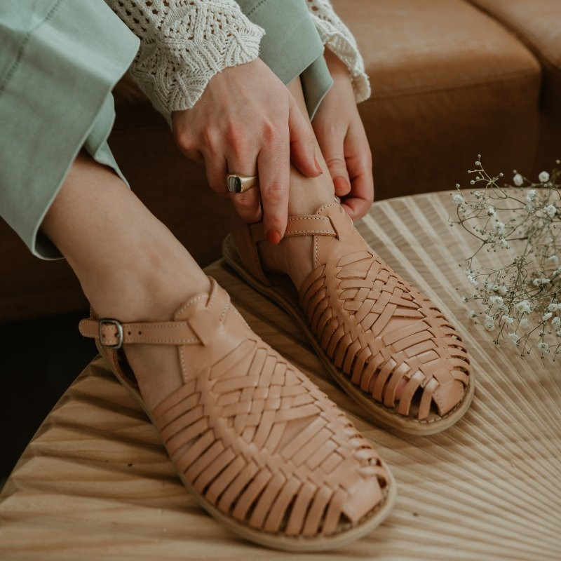 Close up of a woman wearing Origo Huaraches Wide Tan Sandal