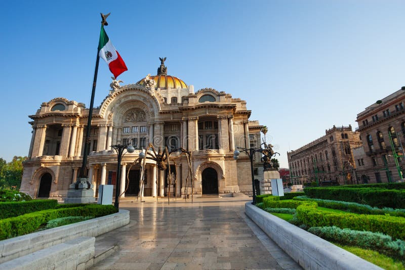 The Mexican flag waving proudly in front of the Palacio de Bellas Artes in Mexico City, symbolizing the nation's rich cultural heritage.
