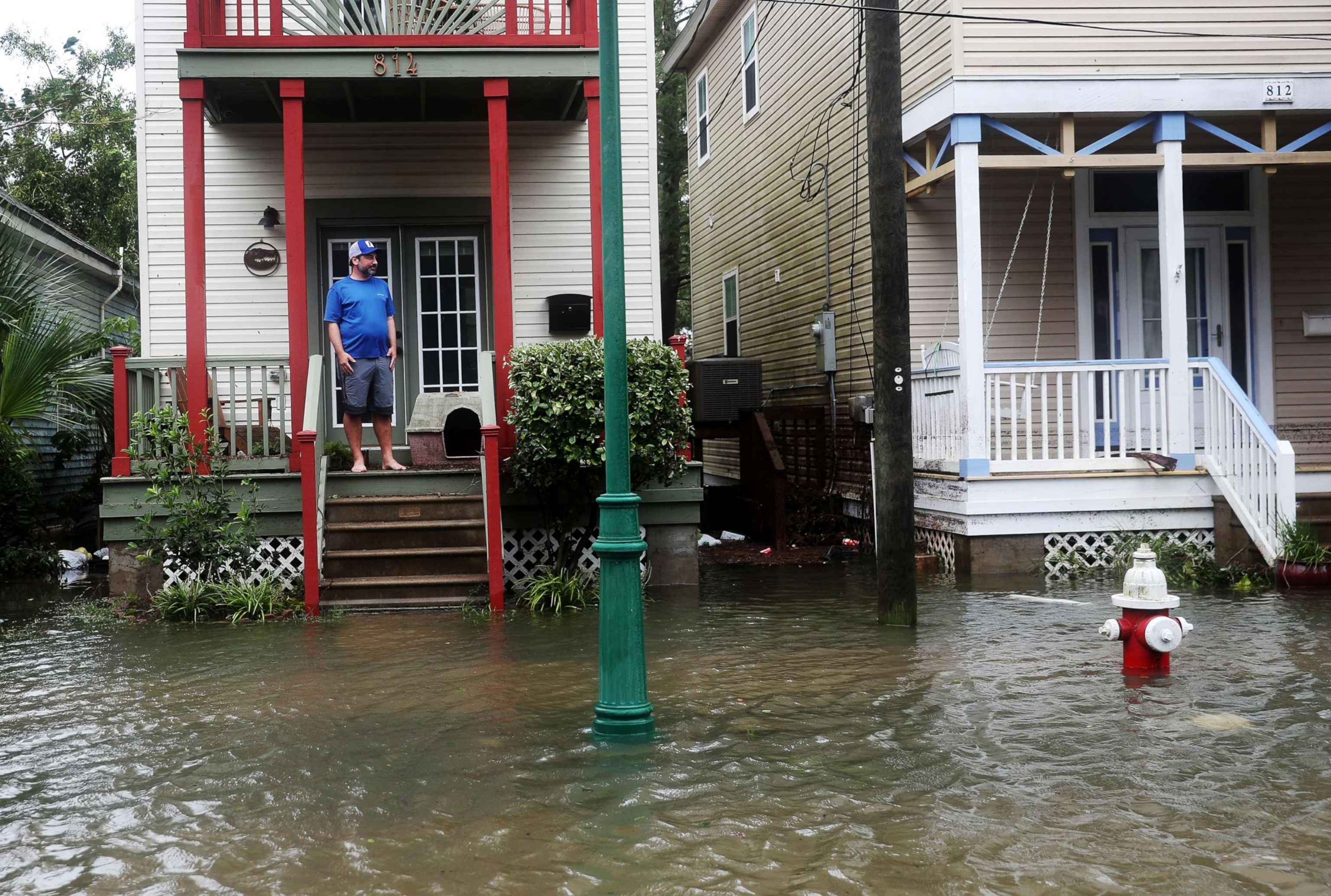 John Terrezza looks out at a flooded street in front of his home as Hurricane Sally passes through the area, in Pensacola, Fla.