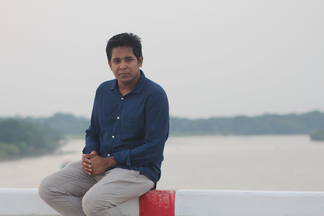 man-standing-on-beach-near-sea-during-daytime