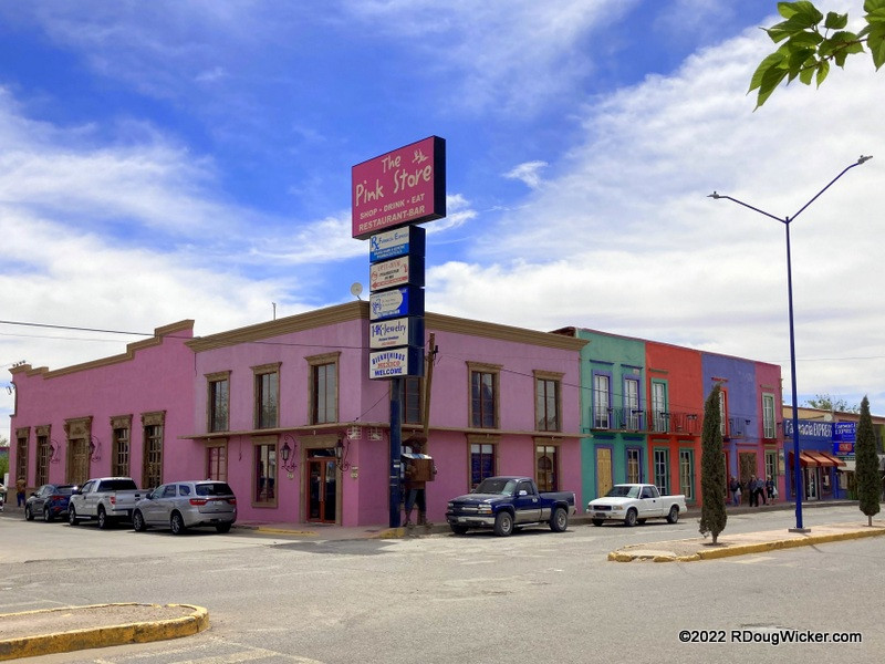 The vibrant exterior of The Pink Store in Palomas, Mexico, beckons visitors to explore its unique blend of Mexican arts, crafts, and souvenirs