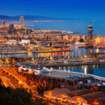 Aerial view of the city of Barcelona, Spain at dusk, indicating potential flight options from Mexico.