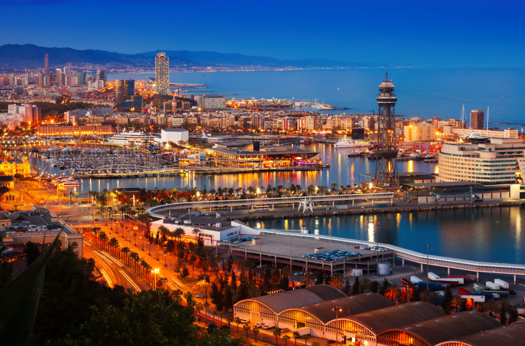 Aerial view of the city of Barcelona, Spain at dusk, indicating potential flight options from Mexico.