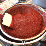 Pushing chile through sieve