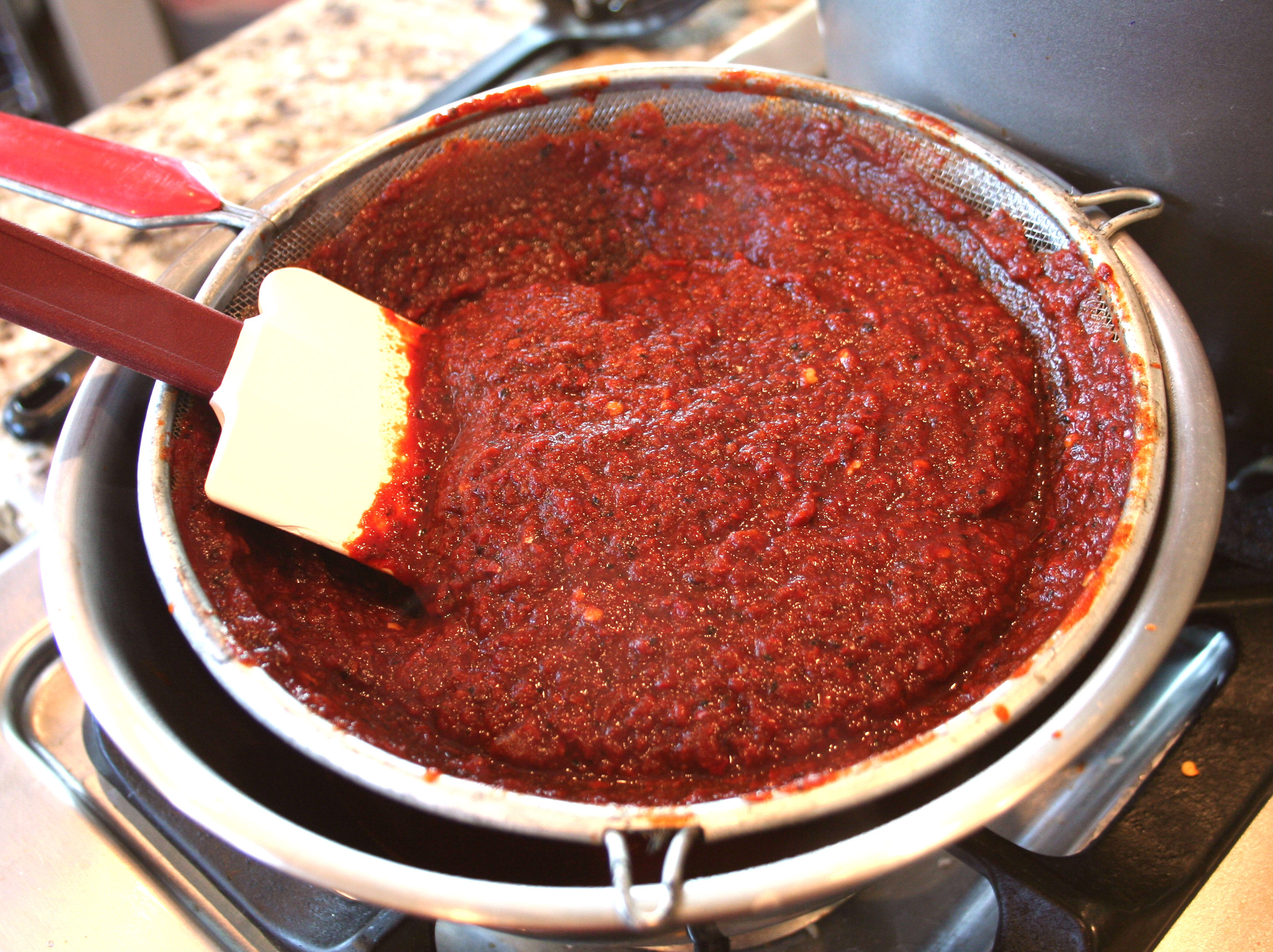 Pushing chile through sieve