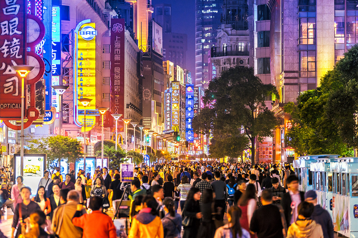 Colourful street full of people at night