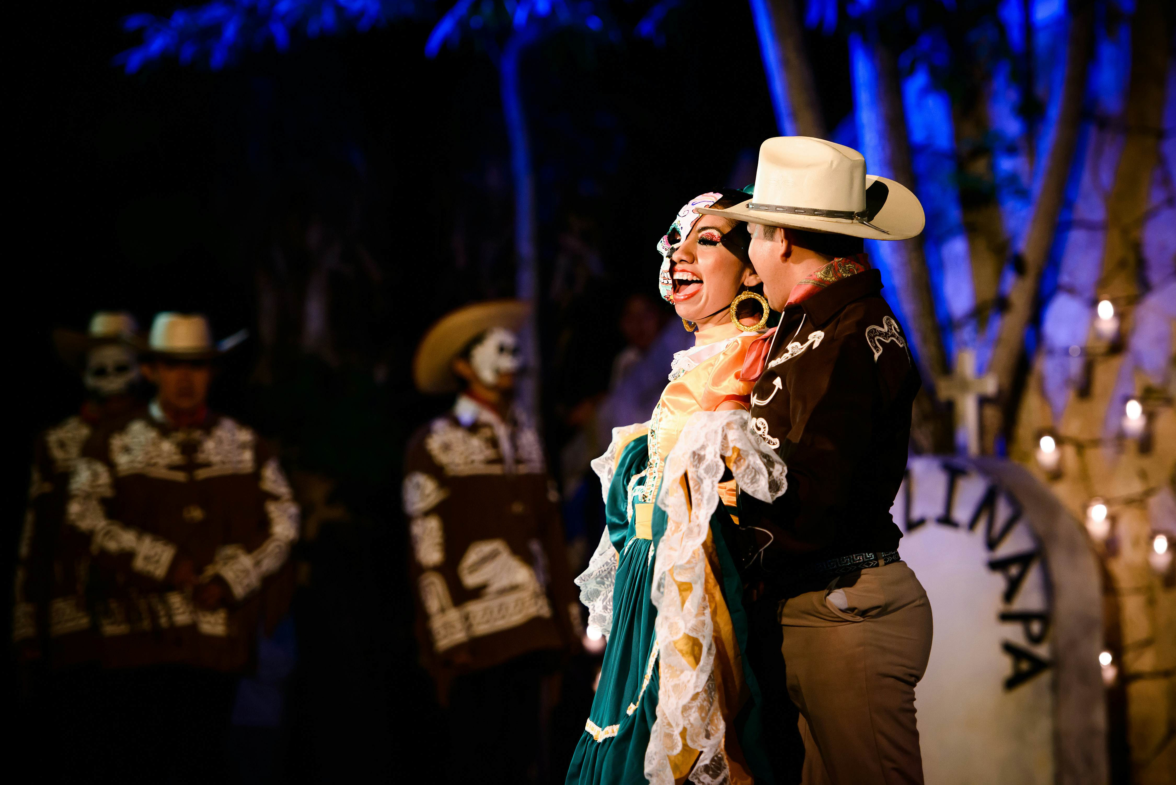 Dancers in costume embrace at a Day of the Dead celebration at Xcaret, Playa del Carmen, Quintana Roo, Mexico