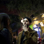 A man smokes a cigarette outside a bar in Monterrey, Mexico