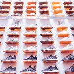Colorful array of shoes displayed at a vibrant tianguis in Mexico, showcasing a diverse selection of styles and materials