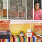 A customer enjoys a meal at a vibrant Mexican food truck in Florida, illustrating the widespread popularity of Mexican cuisine in the U.S.