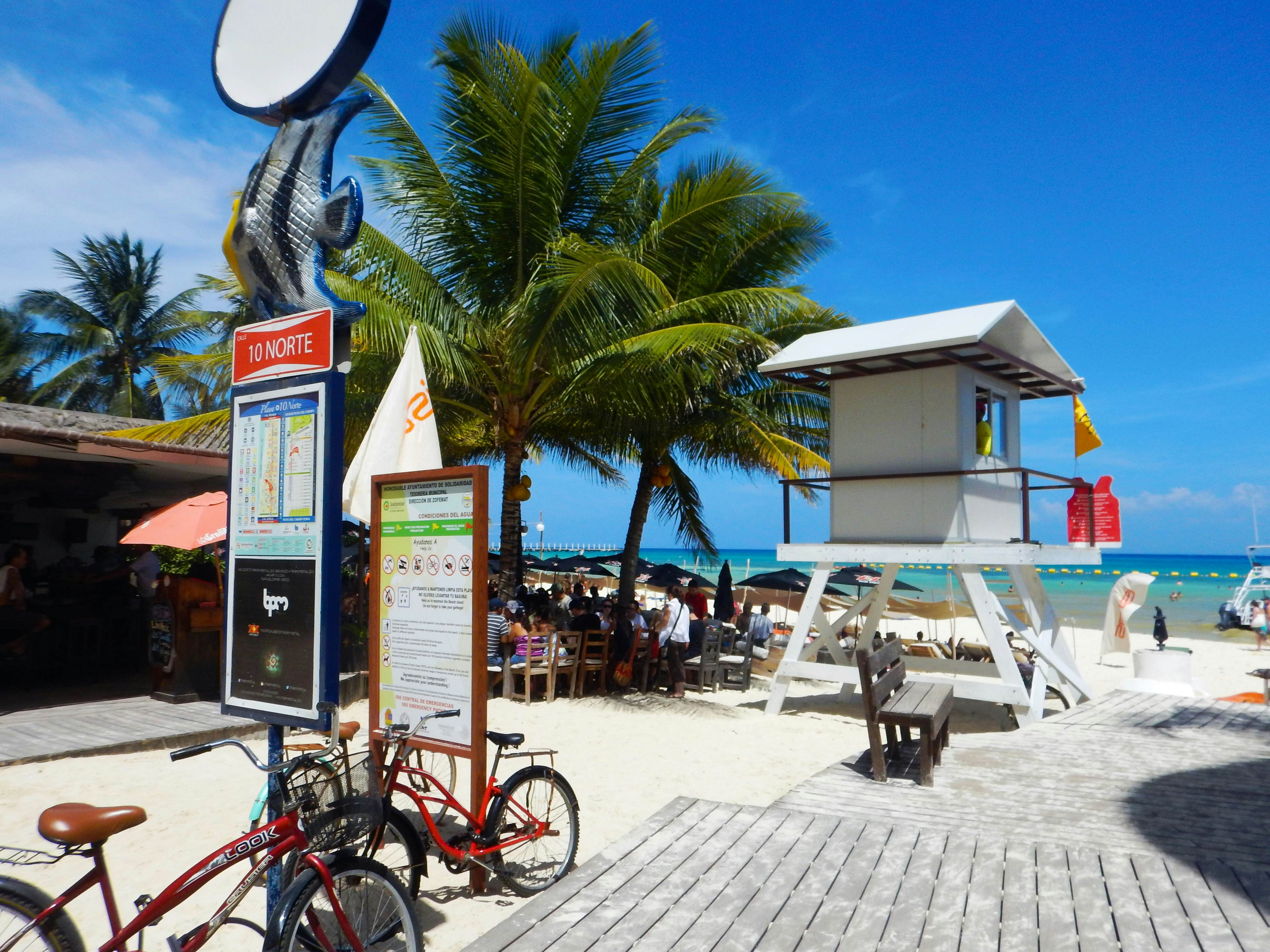 Bicycles parked by a lifeguard station on a boardwalk by the beach in Playa del Carmen