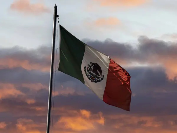 Sunset view of the Mexican flag in Mexico City, symbolizing patriotism and national identity