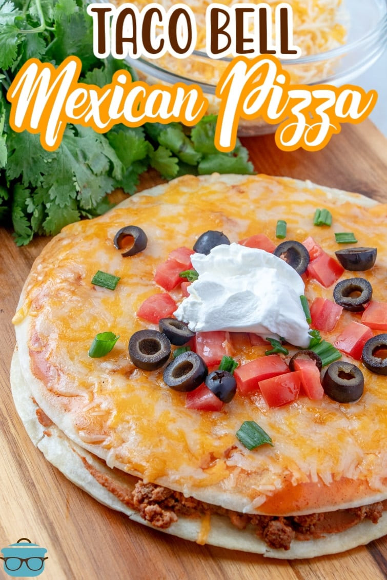 People enjoying a Mexican pizza, topped with tomatoes and green onions, at an outdoor gathering.