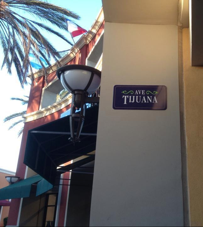 A bustling street in Tijuana showcasing vibrant colors, local shops, and the lively atmosphere of the city.