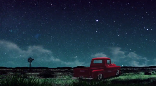 A classic Chevy sits against a desert backdrop, evoking themes of nostalgia, discovery, and the search for identity within the vast landscape of life.