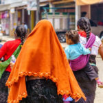 A vibrant street scene in Mexico with colorful buildings and people walking.
