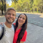 Man in white shirt and woman in red top by Parque España showing a friendly atmosphere