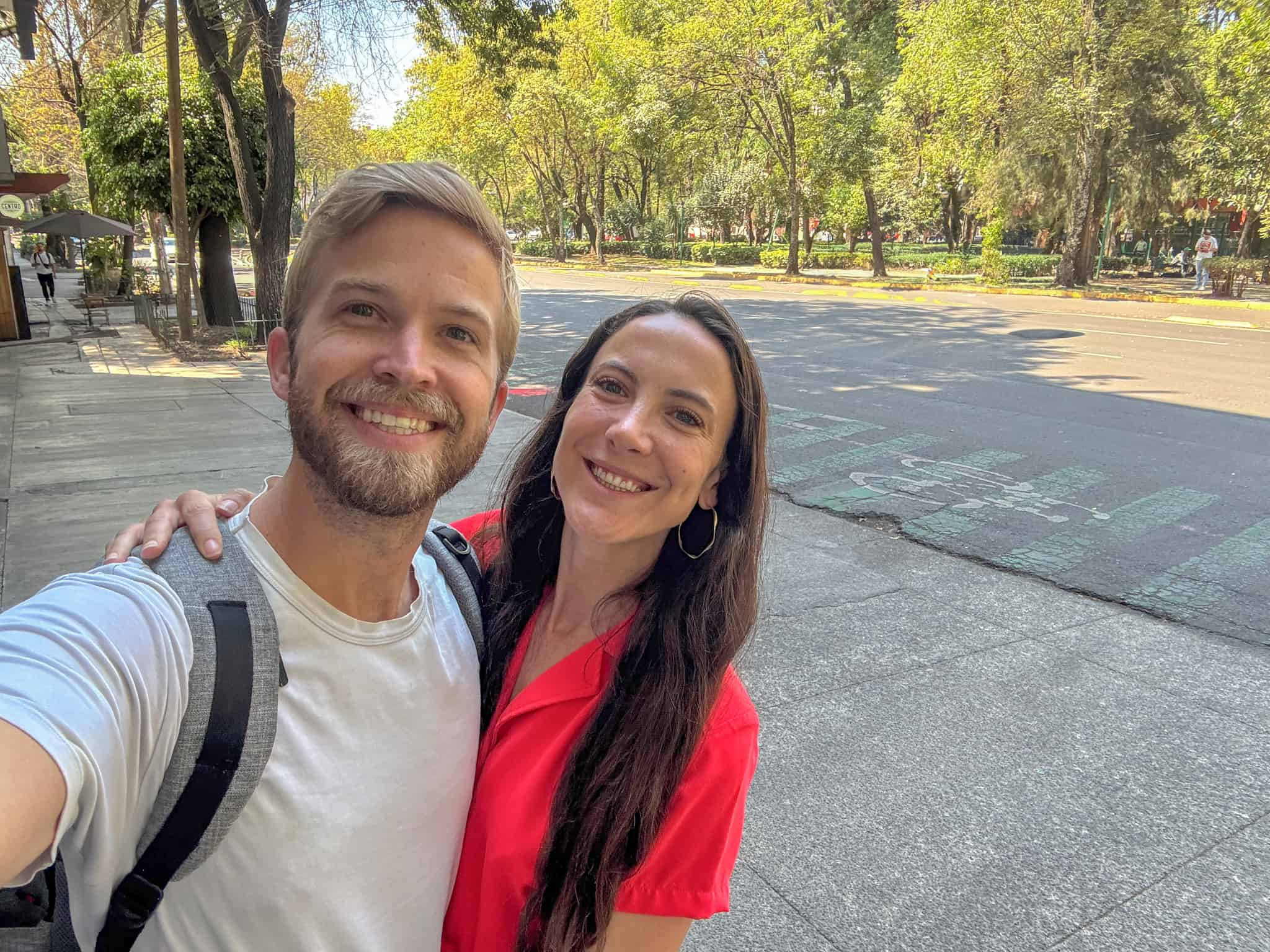 man in white shirt and woman in red top by parque españa for where to stay in mexico city