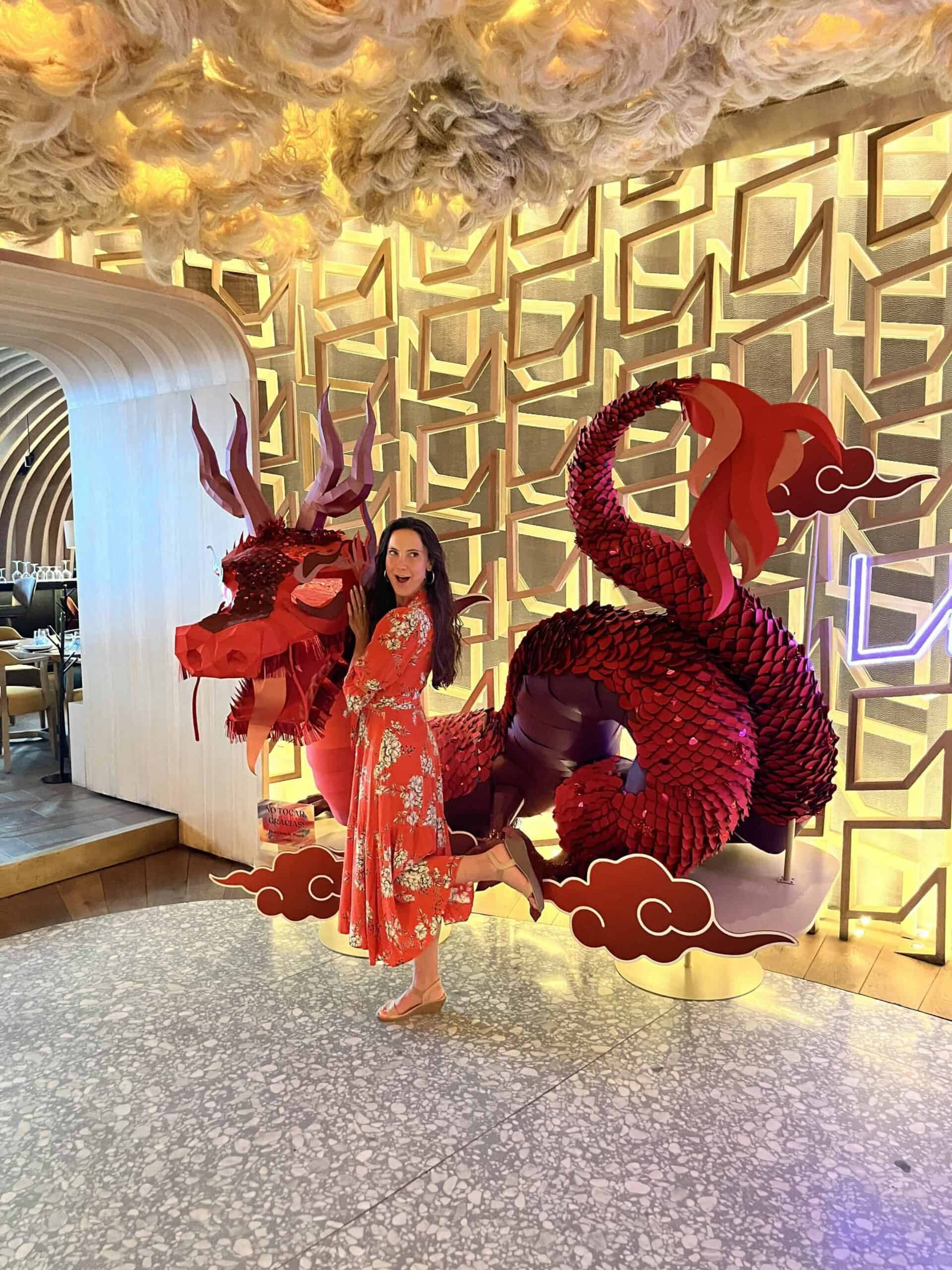 woman in red dress in front of dragon scultpture at ling ling for where to stay in mexico city