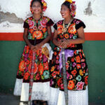 Women in richly embroidered Tehuana clothing for the Feast of the Assumption in Santa María Reoloteca, Tehuantepec, Oaxaca state.