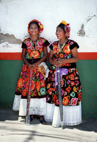 Women in richly embroidered Tehuana clothing for the Feast of the Assumption in Santa María Reoloteca, Tehuantepec, Oaxaca state.
